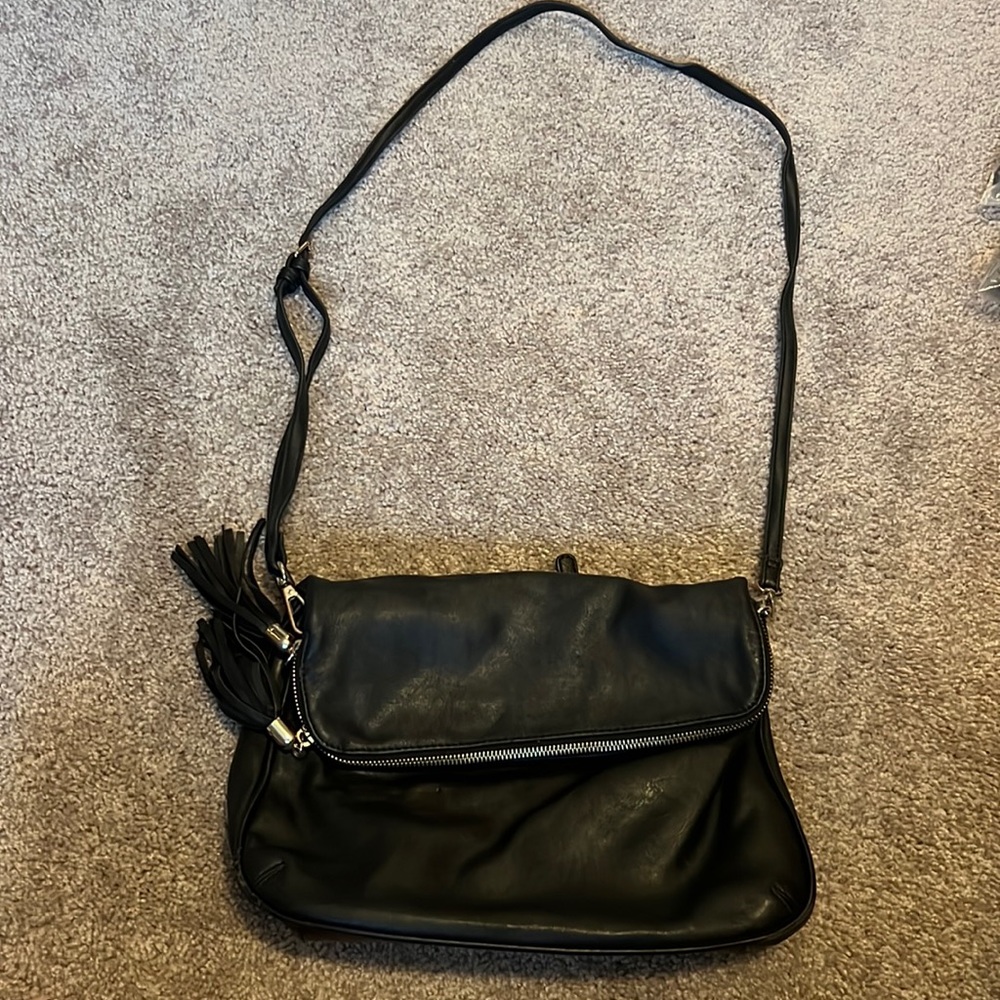 Black crossbody with leopard print inside. Faux black leather.